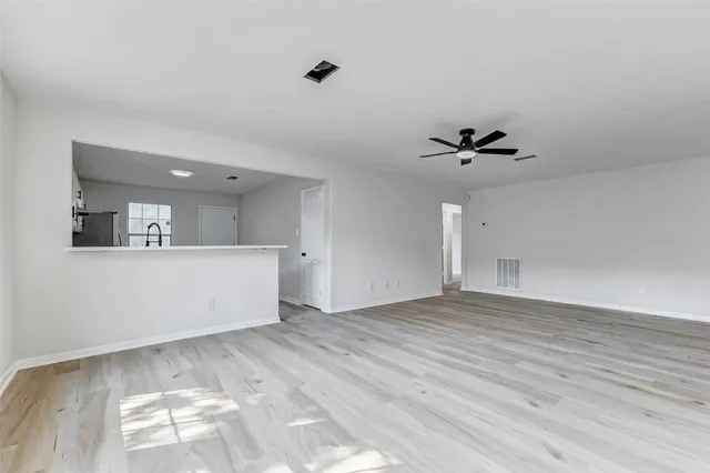 a view of a kitchen with a sink and cabinets