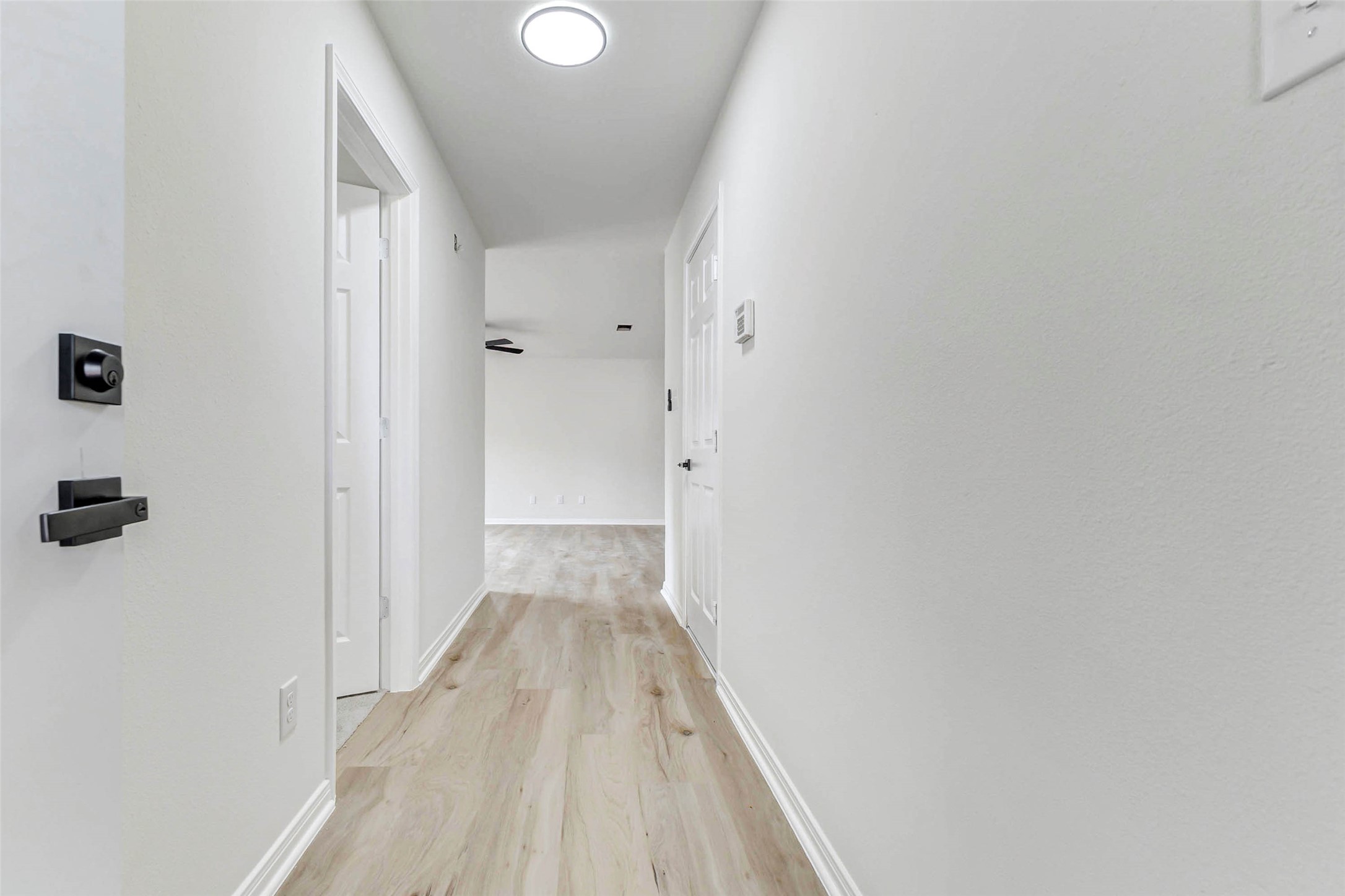 10102 Wiggins Street Houston, TX 77029 - Photo 9 of 26 a view of a hallway with wooden floor