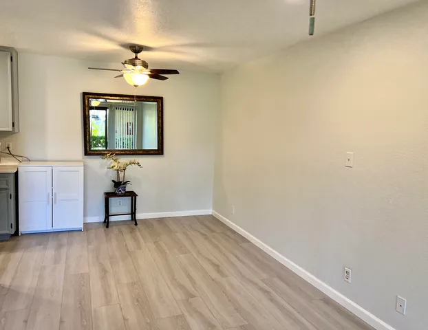 a kitchen with a sink a refrigerator a microwave and cabinets