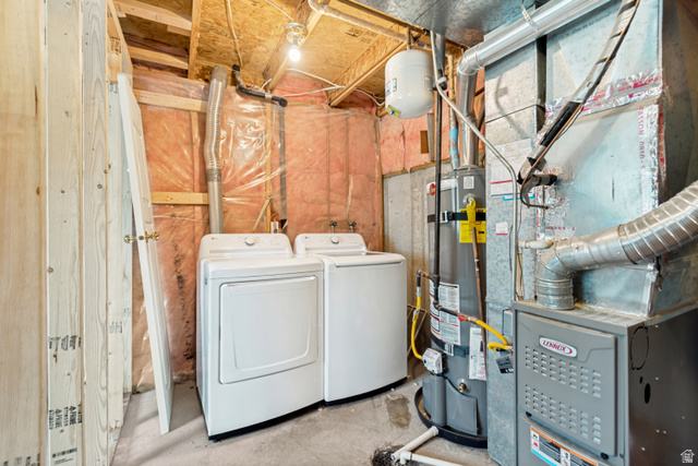 843 Deer Flat Road Tooele, UT 84074 - Photo 22 of 27 Utility space featuring a washer and dryer, a hot water heater, and a furnace unit