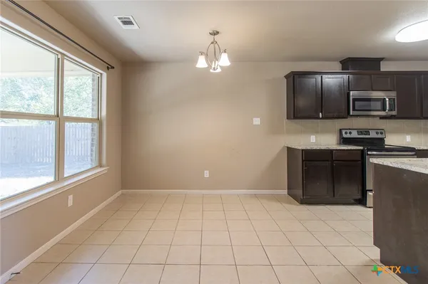 a view of a kitchen with a sink and a microwave
