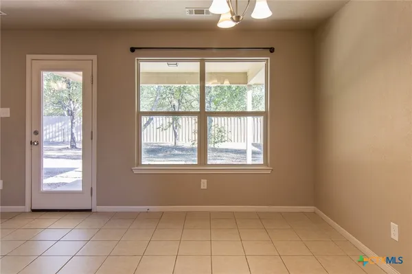 a bathroom with a granite countertop double vanity sink and a mirror