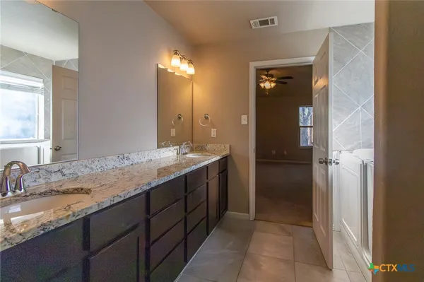 a view of an empty room with wooden floor and closet
