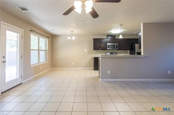 a view of a kitchen with microwave and cabinets