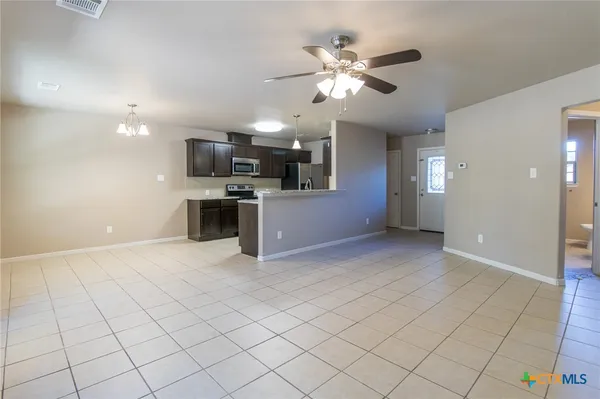 a view of a kitchen with a sink and cabinets