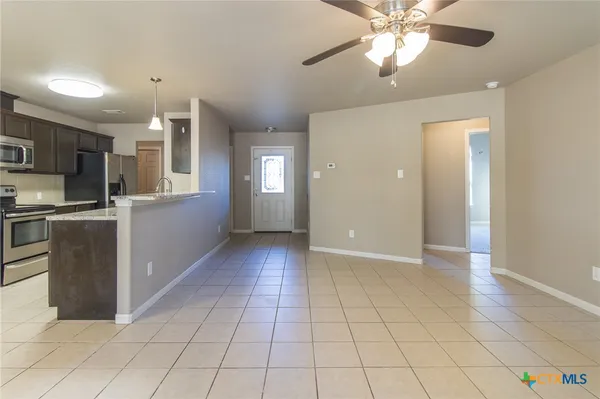 a kitchen with kitchen island a counter top space appliances and a window