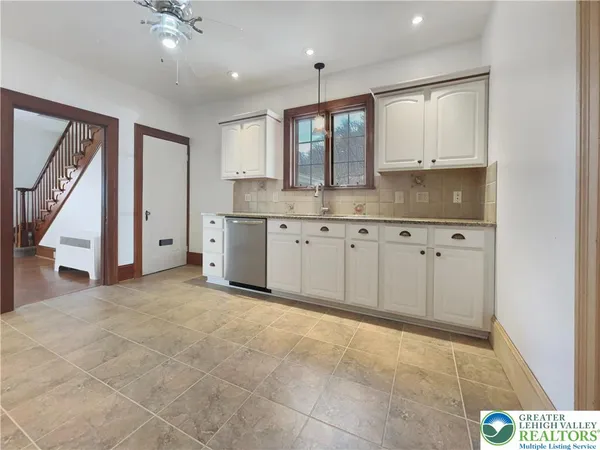 a view of a kitchen with sink and cabinet