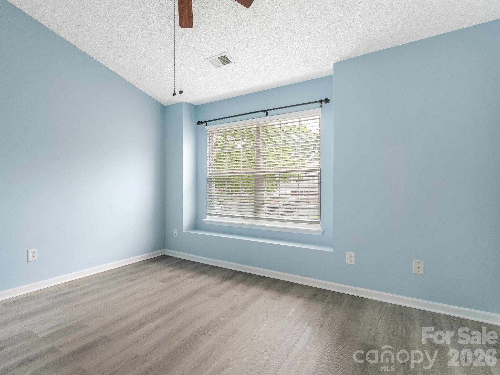 3259 Blythe Ridge Court Charlotte, NC 28213 - Photo 12 of 17 an empty room with wooden floor and windows