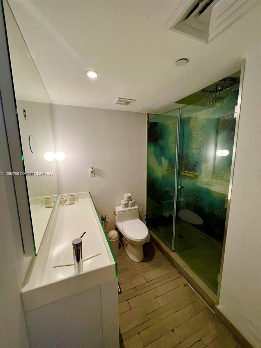 1100 West Avenue, Unit 425 Miami Beach, FL 33139 - Photo 12 of 17 a bathroom with a sink and mirror