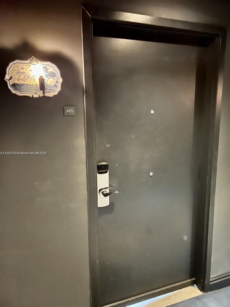 1100 West Avenue, Unit 425 Miami Beach, FL 33139 - Photo 16 of 17 a bathroom with a light fixture and a mirror