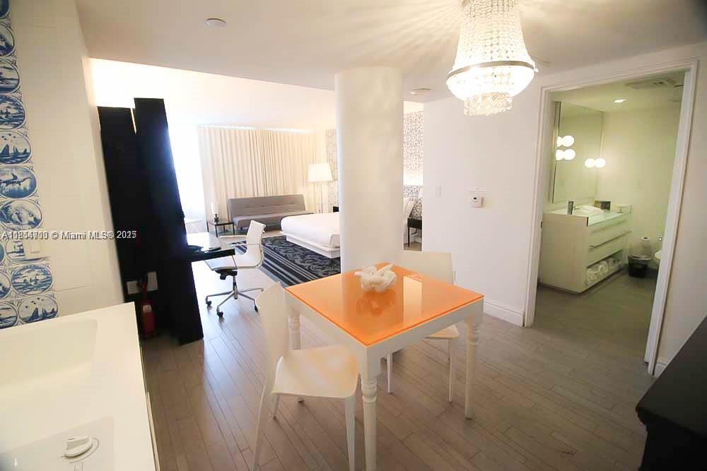 1100 West Avenue, Unit 425 Miami Beach, FL 33139 - Photo 6 of 17 a living room with furniture and a chandelier