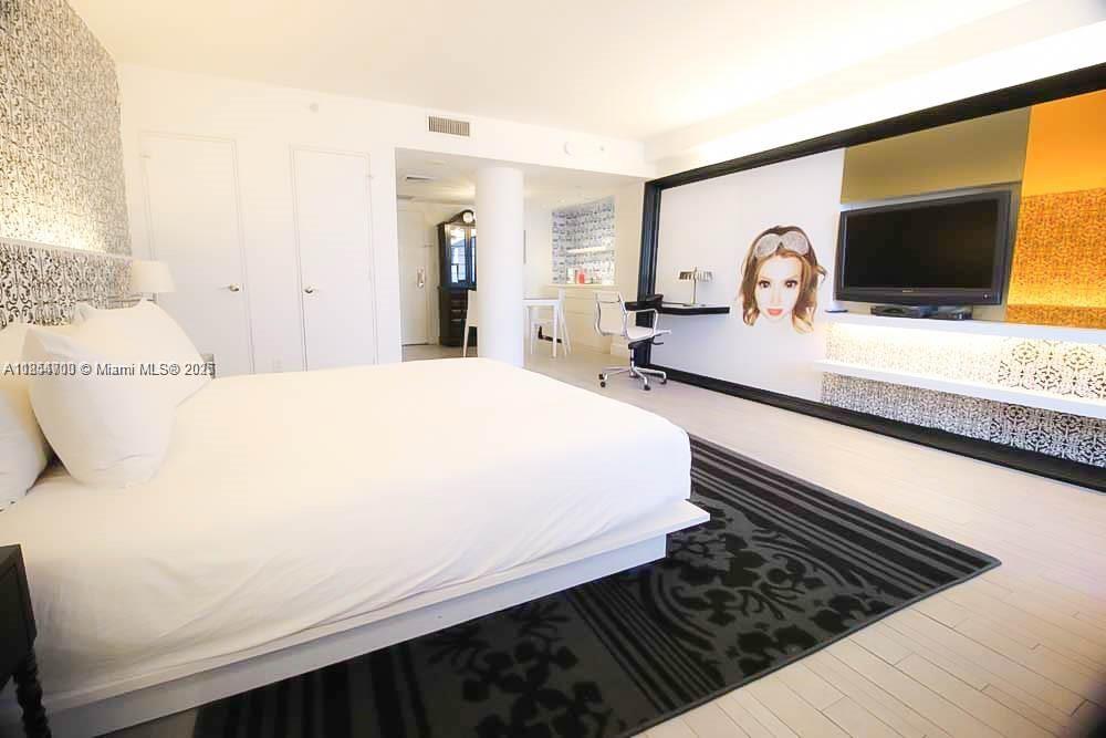 1100 West Avenue, Unit 425 Miami Beach, FL 33139 - Photo 9 of 17 a bedroom with a bed and a flat screen tv