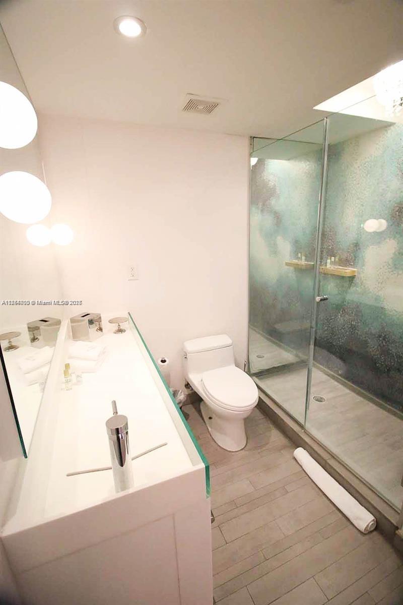 1100 West Avenue, Unit 425 Miami Beach, FL 33139 - Photo 10 of 17 a bathroom with a bathtub and a toilet