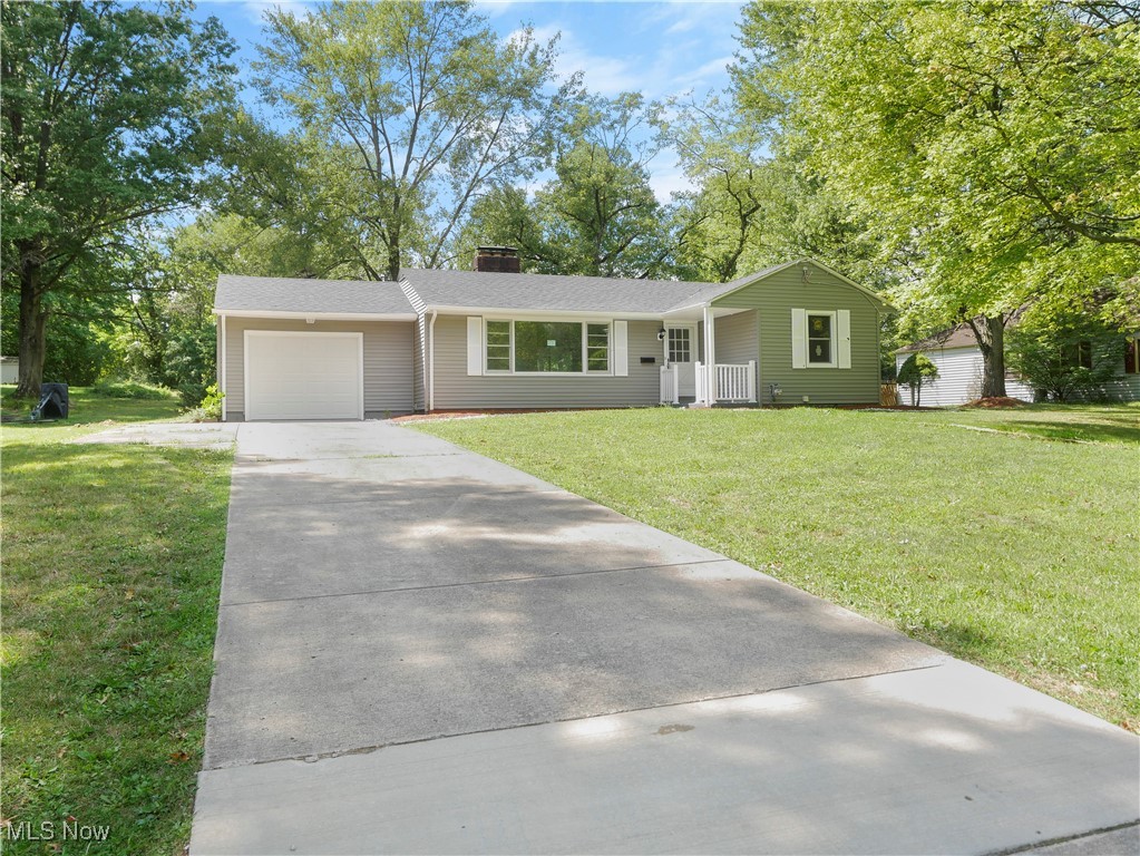 Ranch-style home with a garage and a front yard