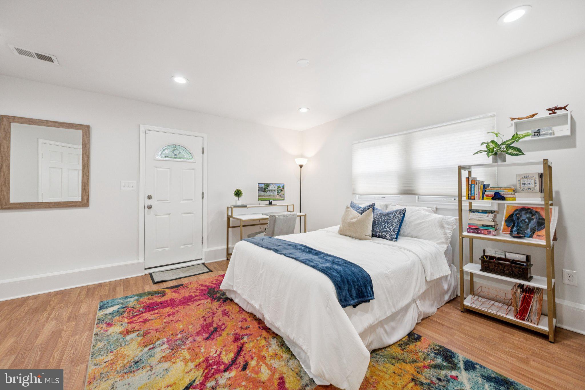 4014 37th Street Mount Rainier, MD 20712 - Photo 11 of 26 a bed room with a bed a dresser and book shelf