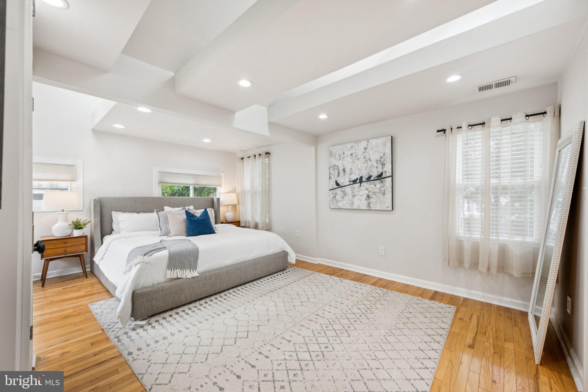 4014 37th Street Mount Rainier, MD 20712 - Photo 15 of 26 a spacious bedroom with a large bed and a couch