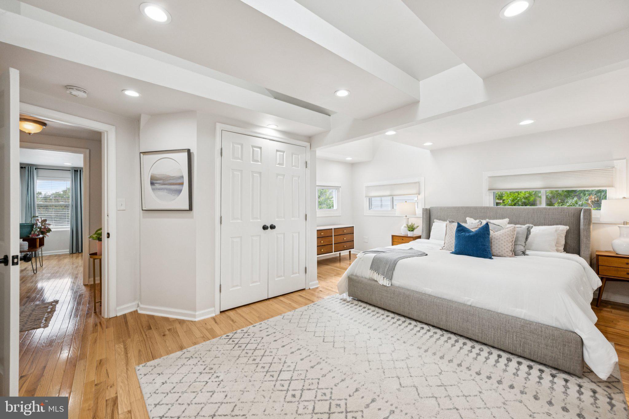 4014 37th Street Mount Rainier, MD 20712 - Photo 16 of 26 a bedroom with a large bed and a couch