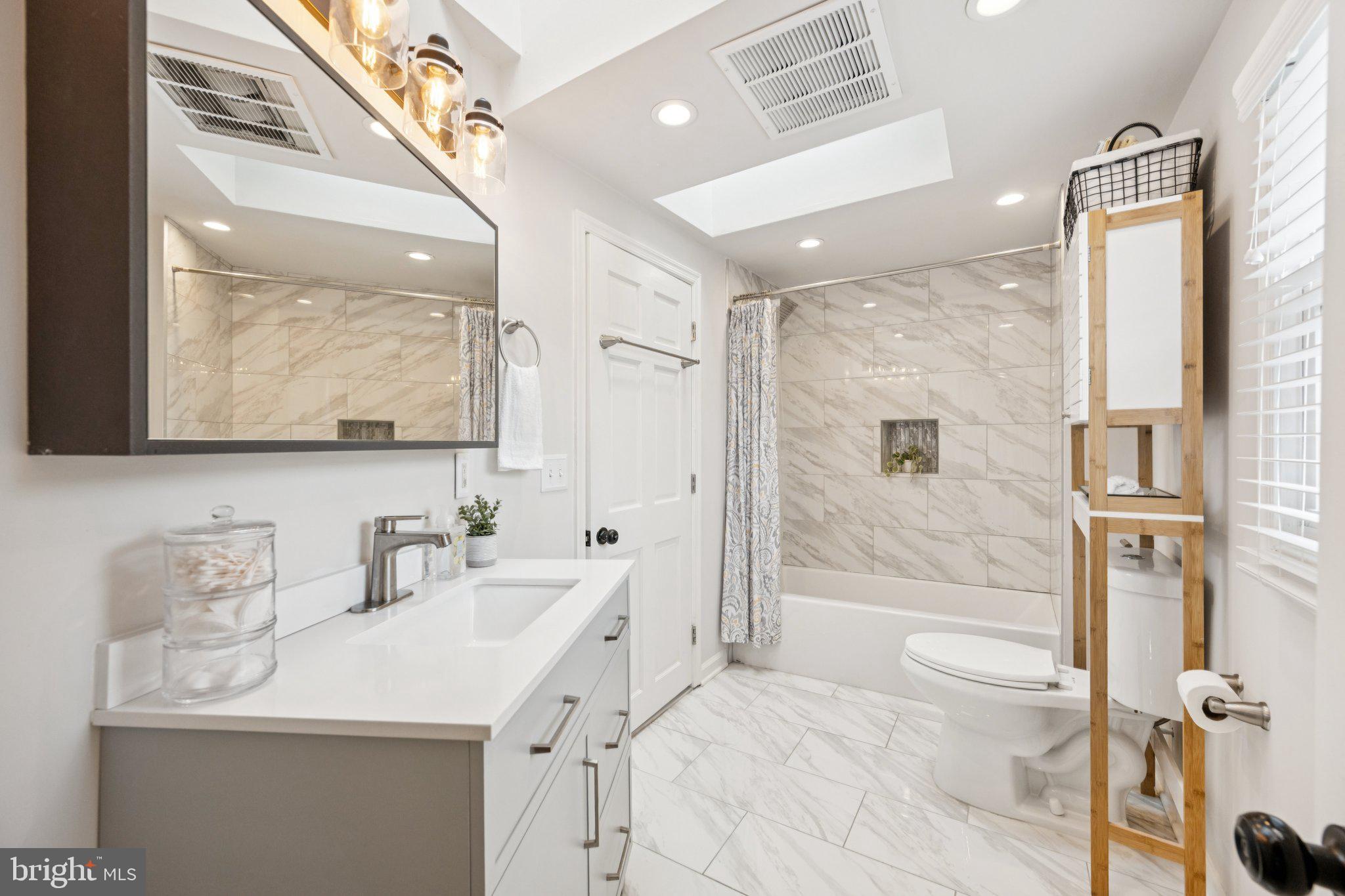 4014 37th Street Mount Rainier, MD 20712 - Photo 18 of 26 a bathroom with a sink a toilet and shower