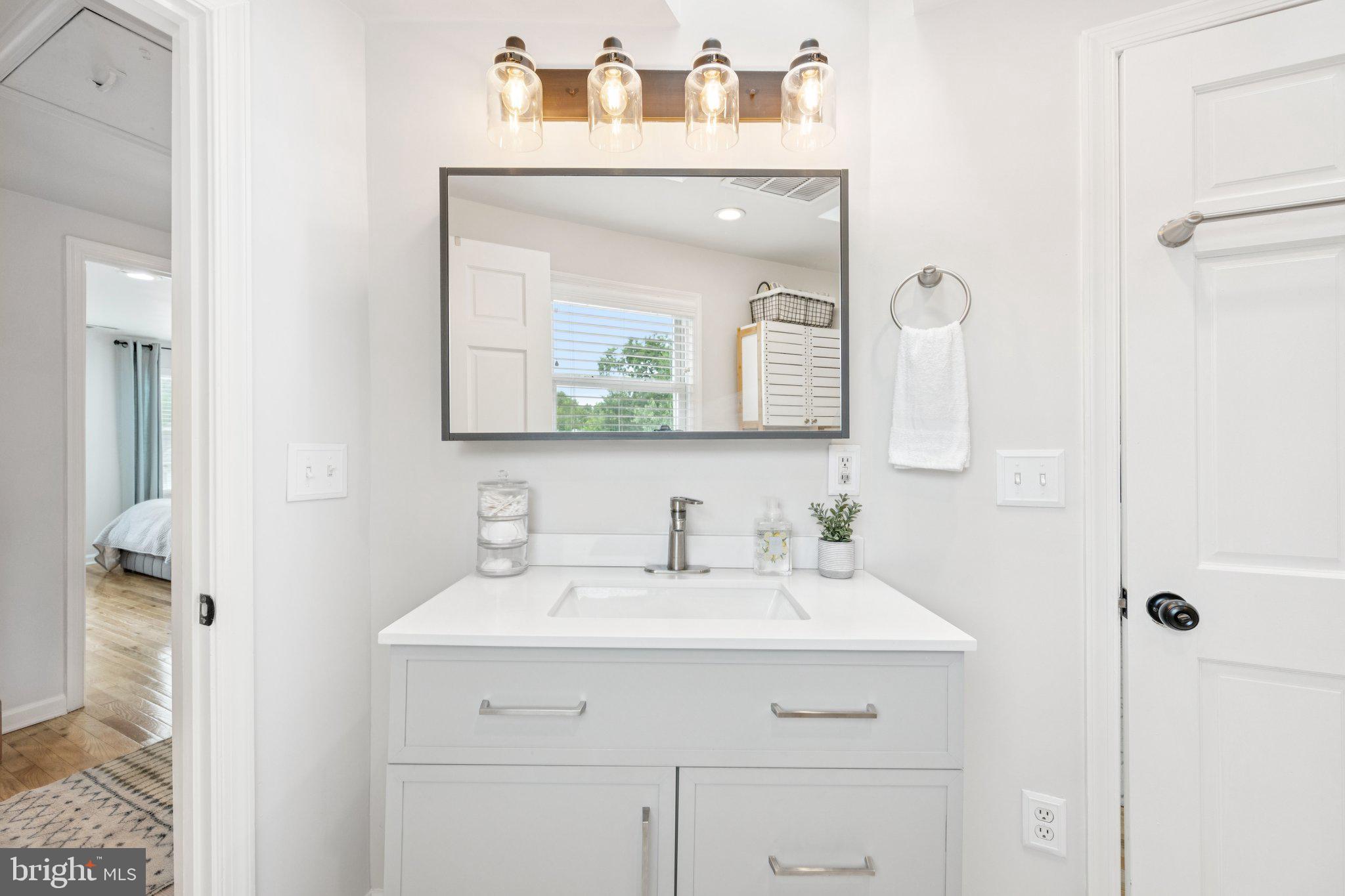 4014 37th Street Mount Rainier, MD 20712 - Photo 19 of 26 a bathroom with a sink vanity and a mirror