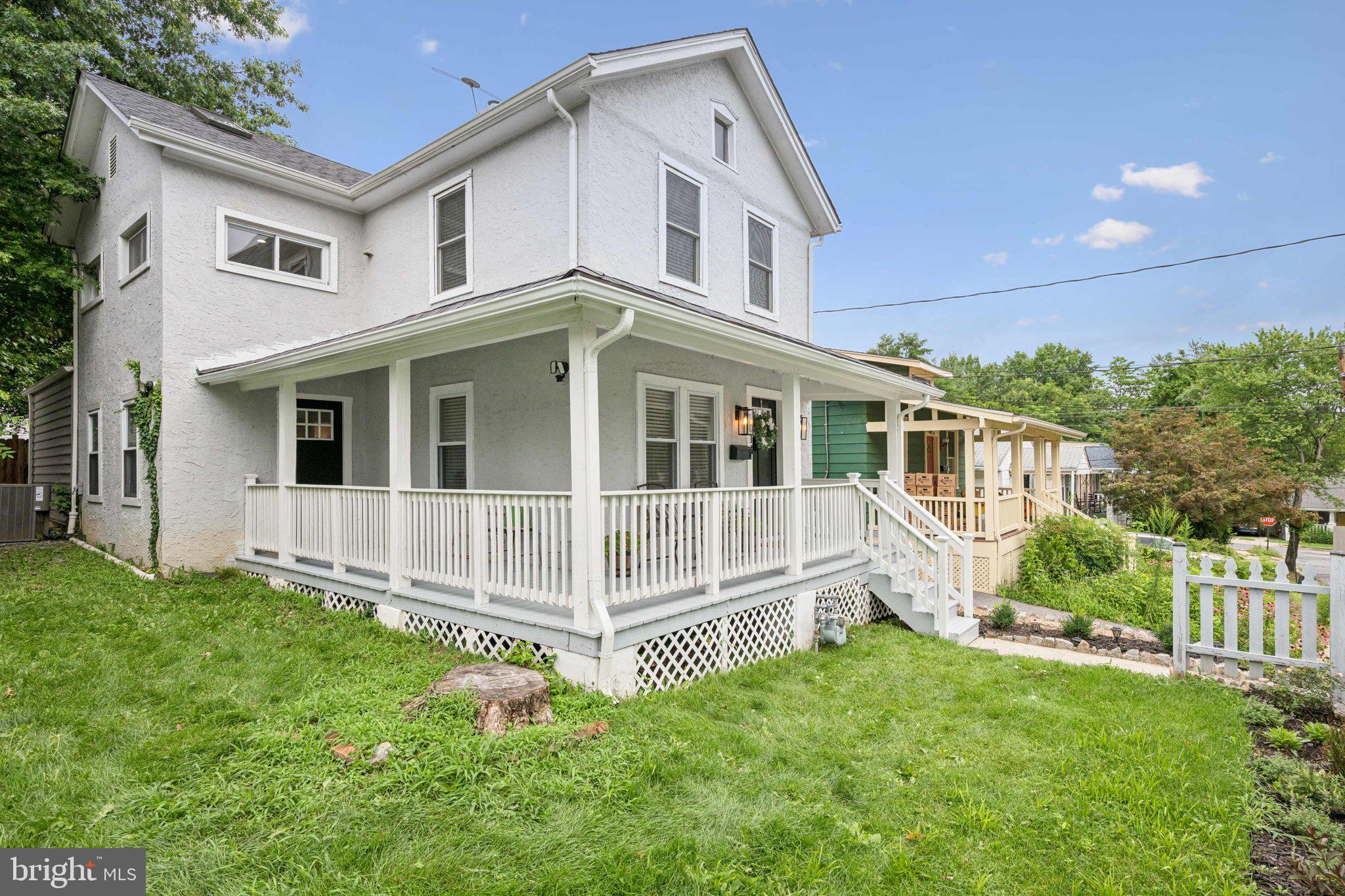 4014 37th Street Mount Rainier, MD 20712 - Photo 22 of 26 a white house that has a small yard and wooden fence