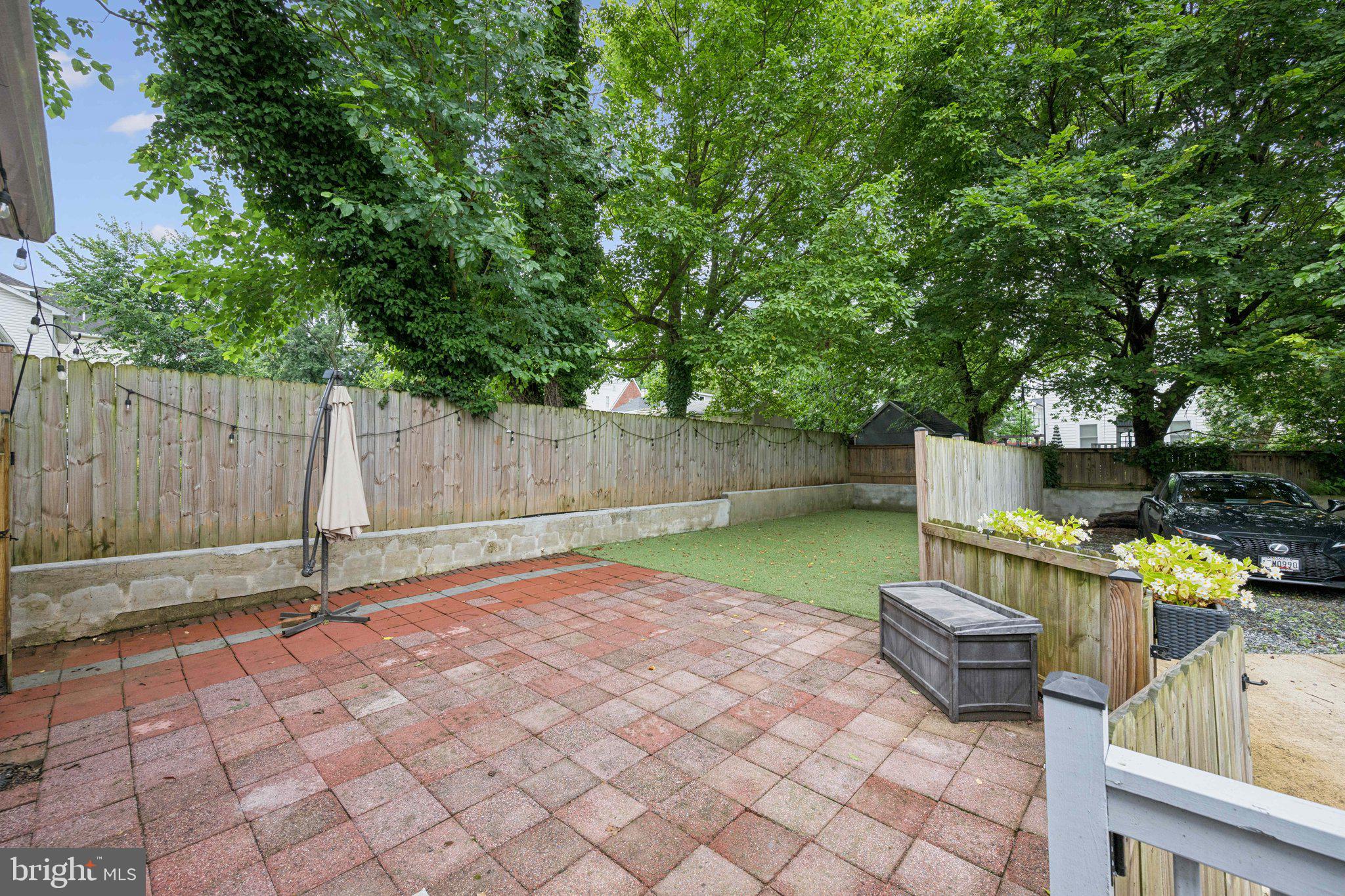 4014 37th Street Mount Rainier, MD 20712 - Photo 23 of 26 a view of a backyard with wooden fence and trees