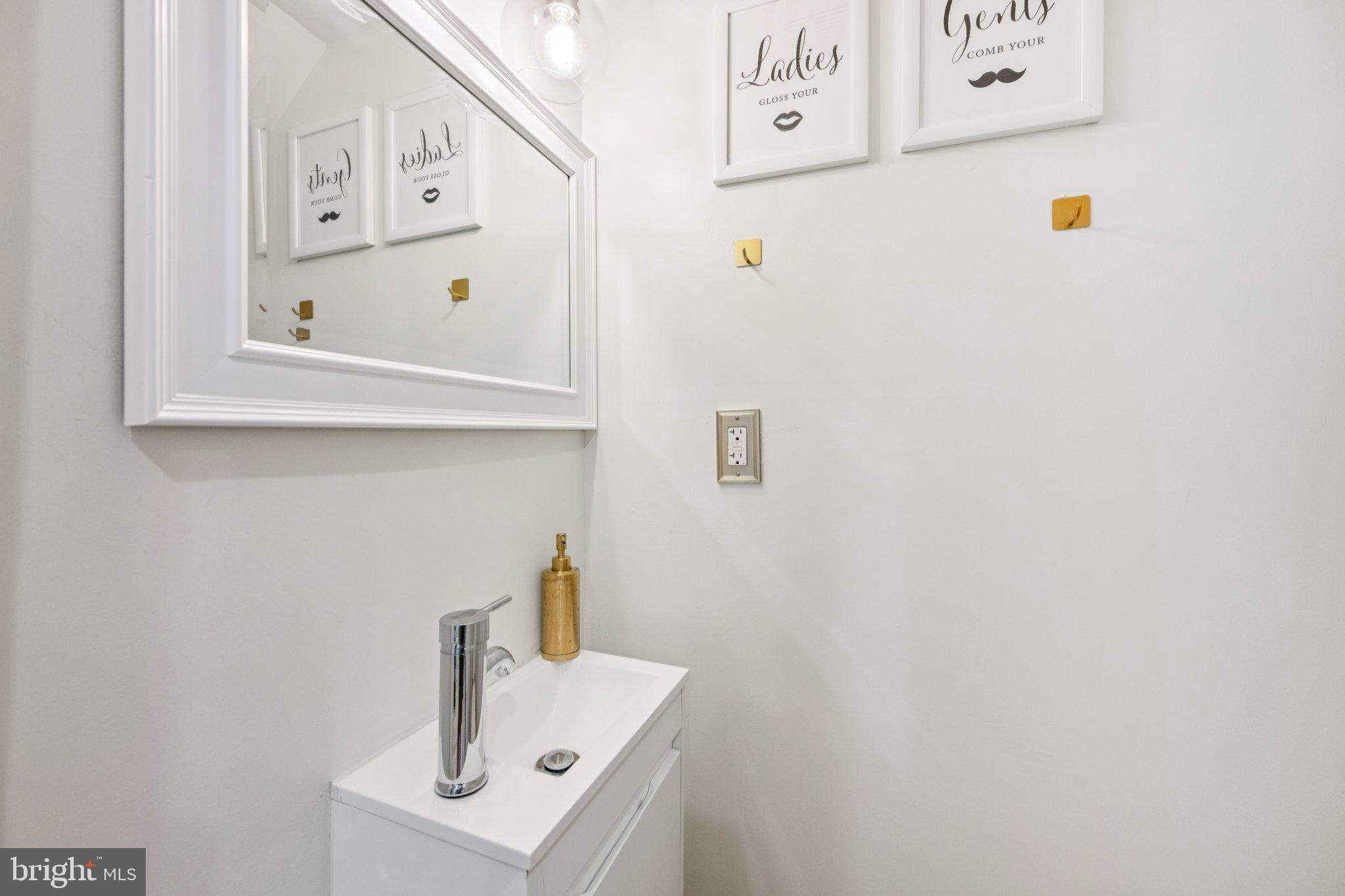 4014 37th Street Mount Rainier, MD 20712 - Photo 10 of 26 a bathroom with a sink and a refrigerator