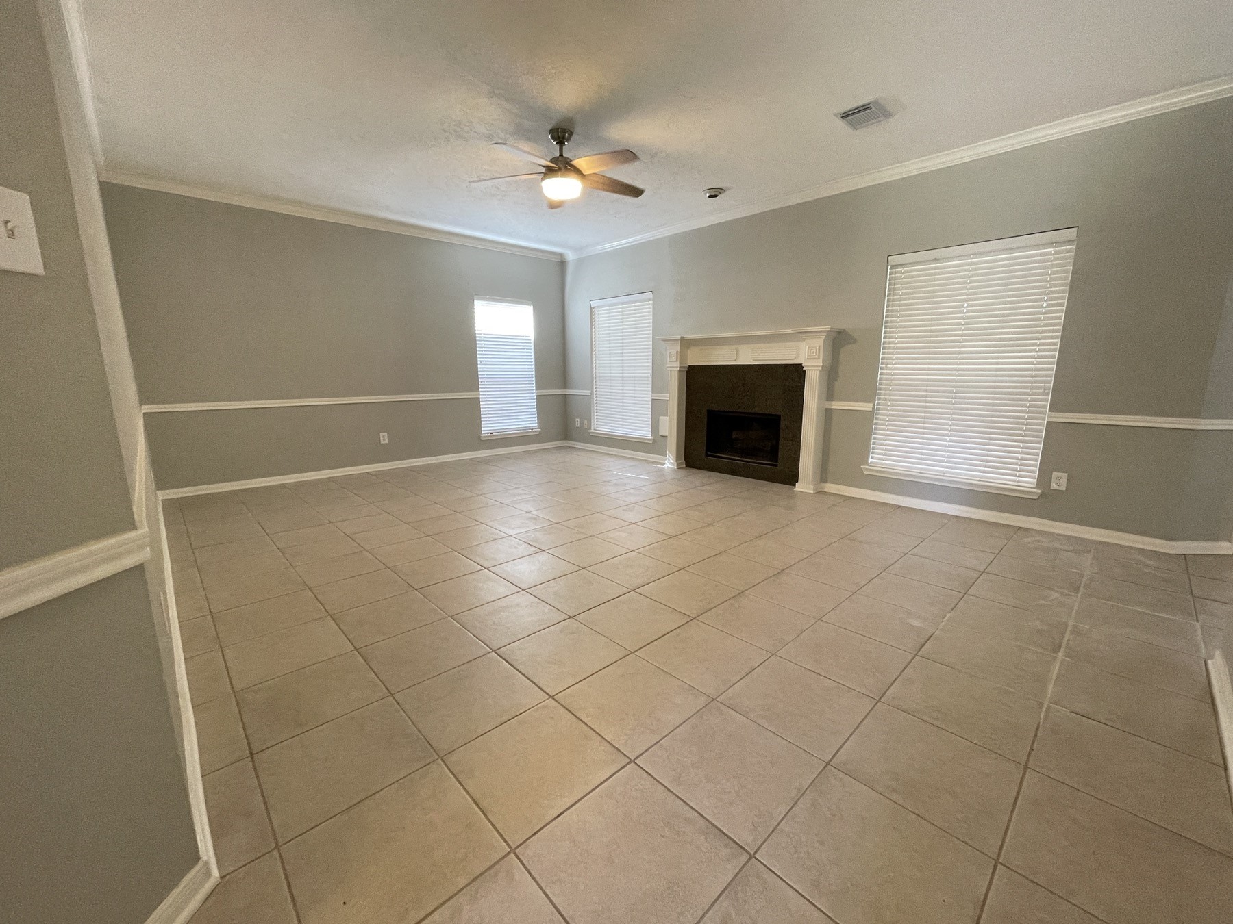 16302 Flint Run Way Sugar Land, TX 77498 - Photo 6 of 27 an empty room with windows and fireplace