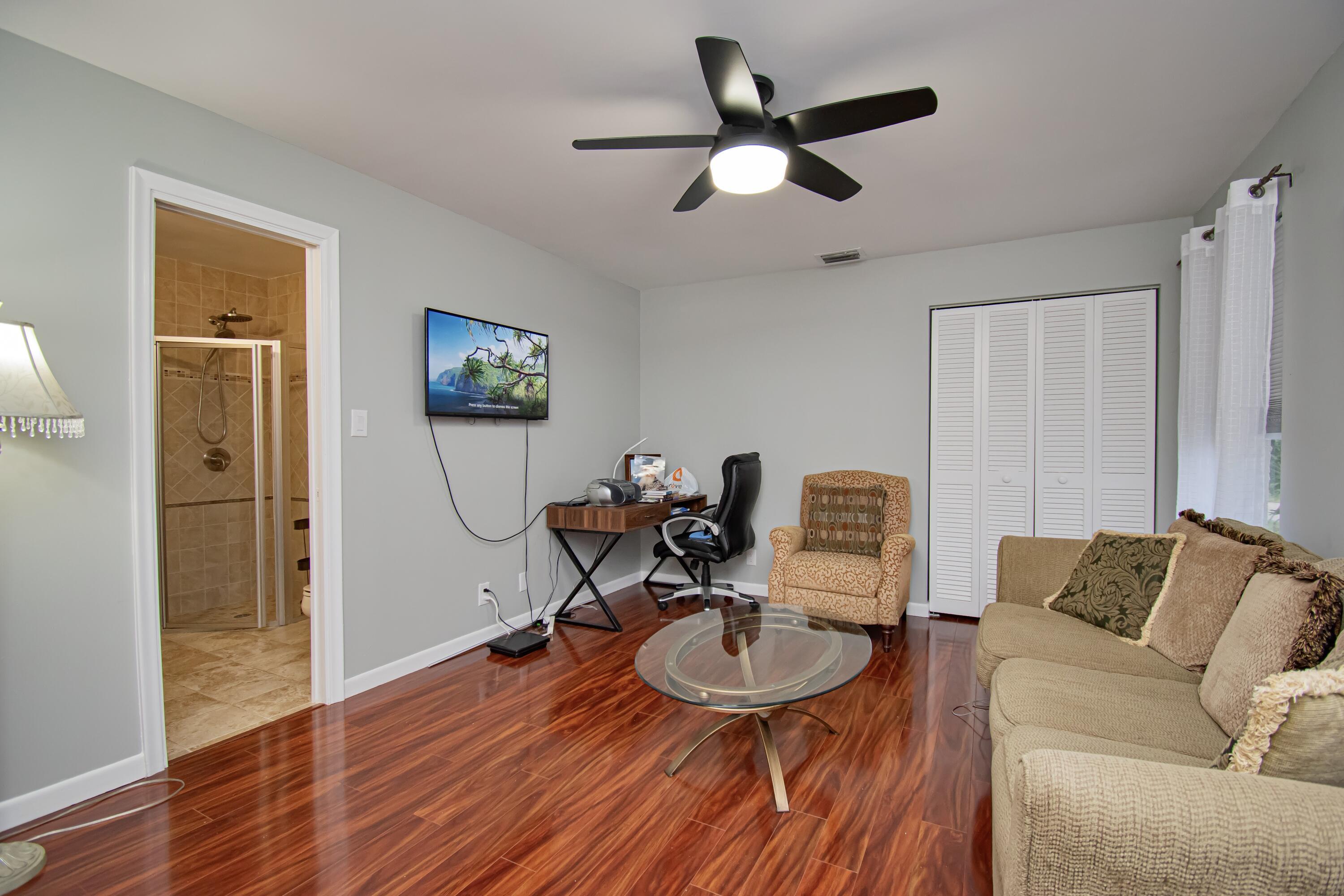 7838 Cypress Crescent Boca Raton, FL 33433 - Photo 17 of 24 a living room with furniture and a wooden floor