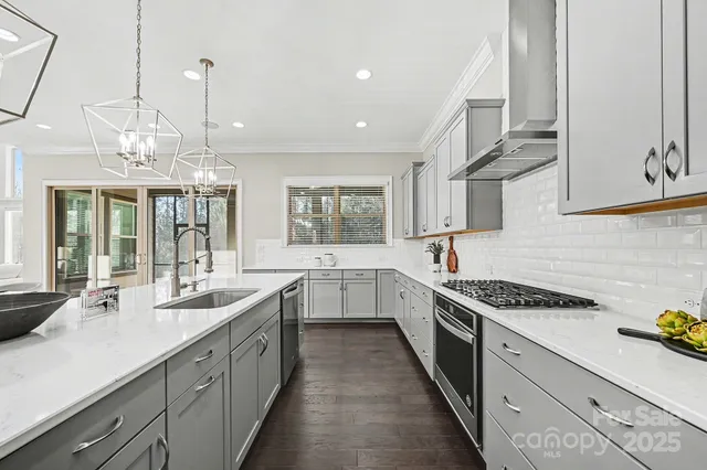 a kitchen with stainless steel appliances a sink stove and cabinets