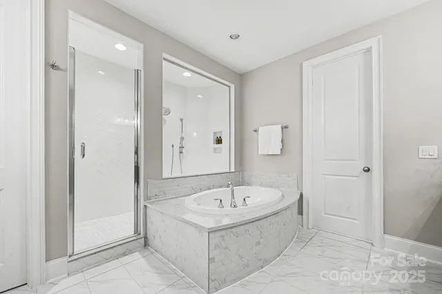 a white bath tub sitting in a en suite bathroom