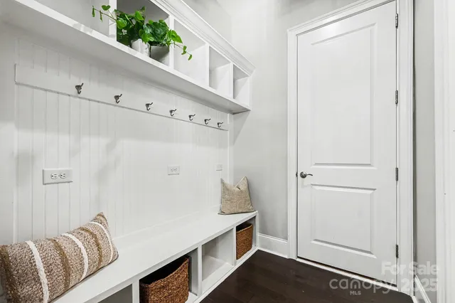 a hallway with white cabinets