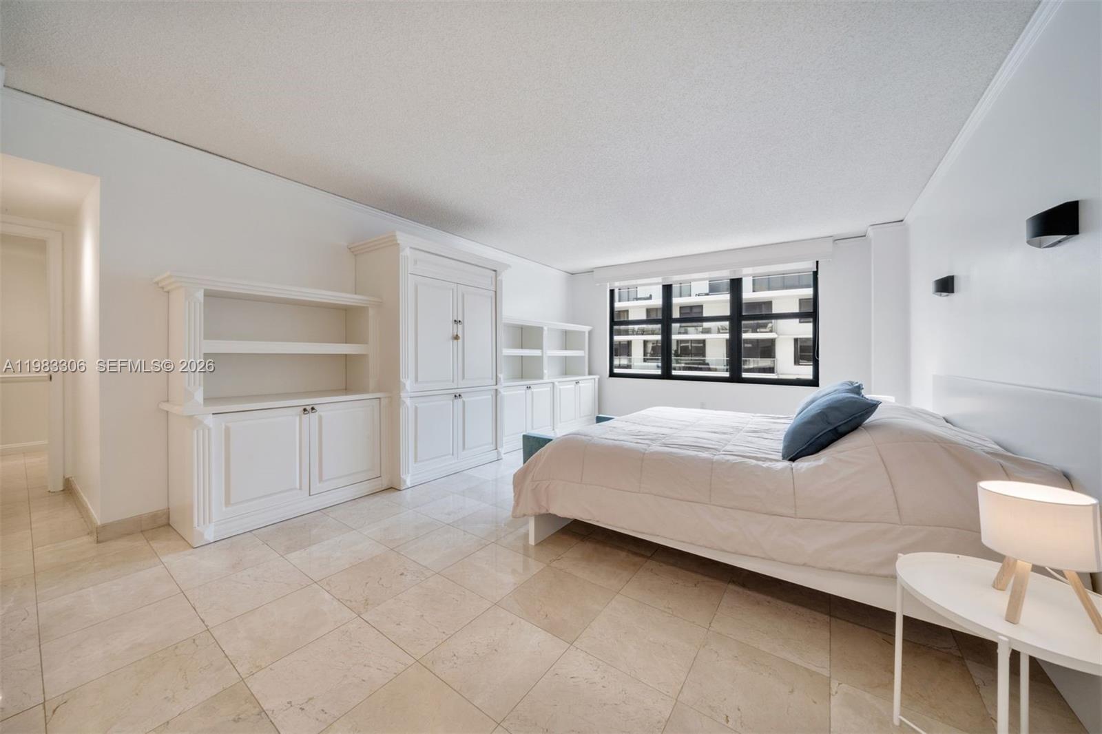 9801 Collins Avenue, Unit 19H Bal Harbour, FL 33154 - Photo 11 of 28 a bedroom with a bed and a view of bathroom