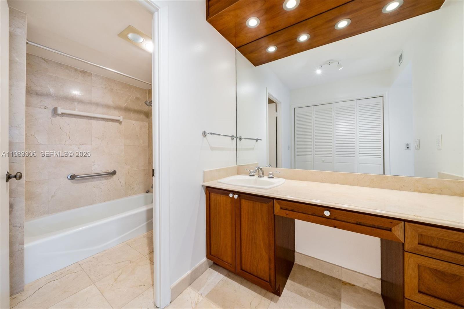9801 Collins Avenue, Unit 19H Bal Harbour, FL 33154 - Photo 16 of 28 a bathroom with a sink and a mirror