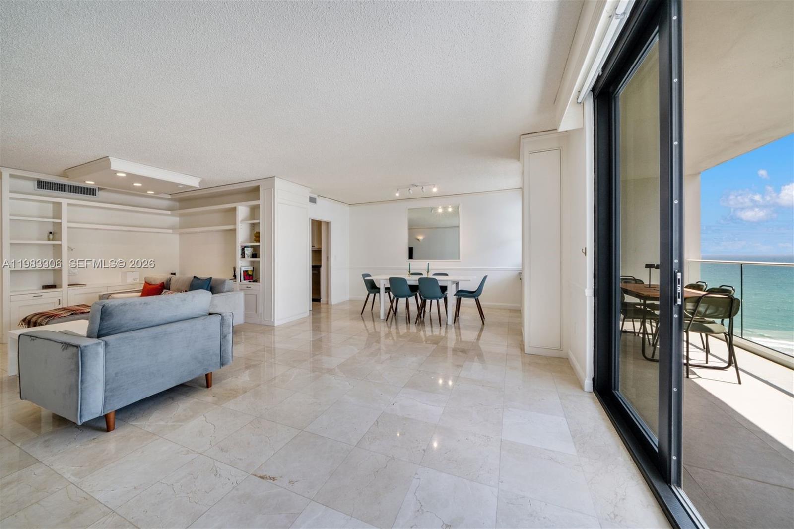 9801 Collins Avenue, Unit 19H Bal Harbour, FL 33154 - Photo 2 of 28 a living room with furniture and a table