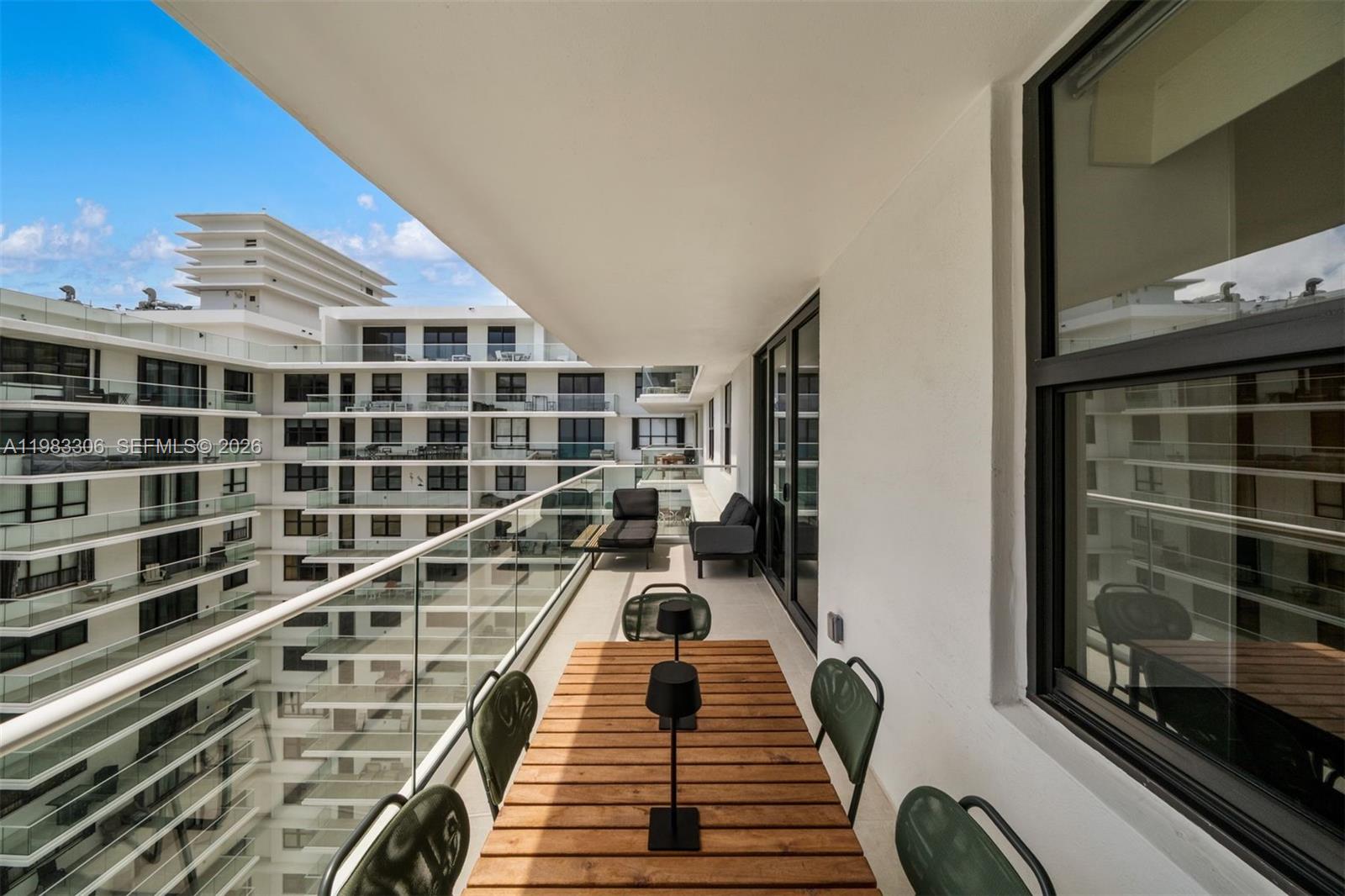 9801 Collins Avenue, Unit 19H Bal Harbour, FL 33154 - Photo 28 of 28 a picture of a balcony with a floor to ceiling window and wooden floor