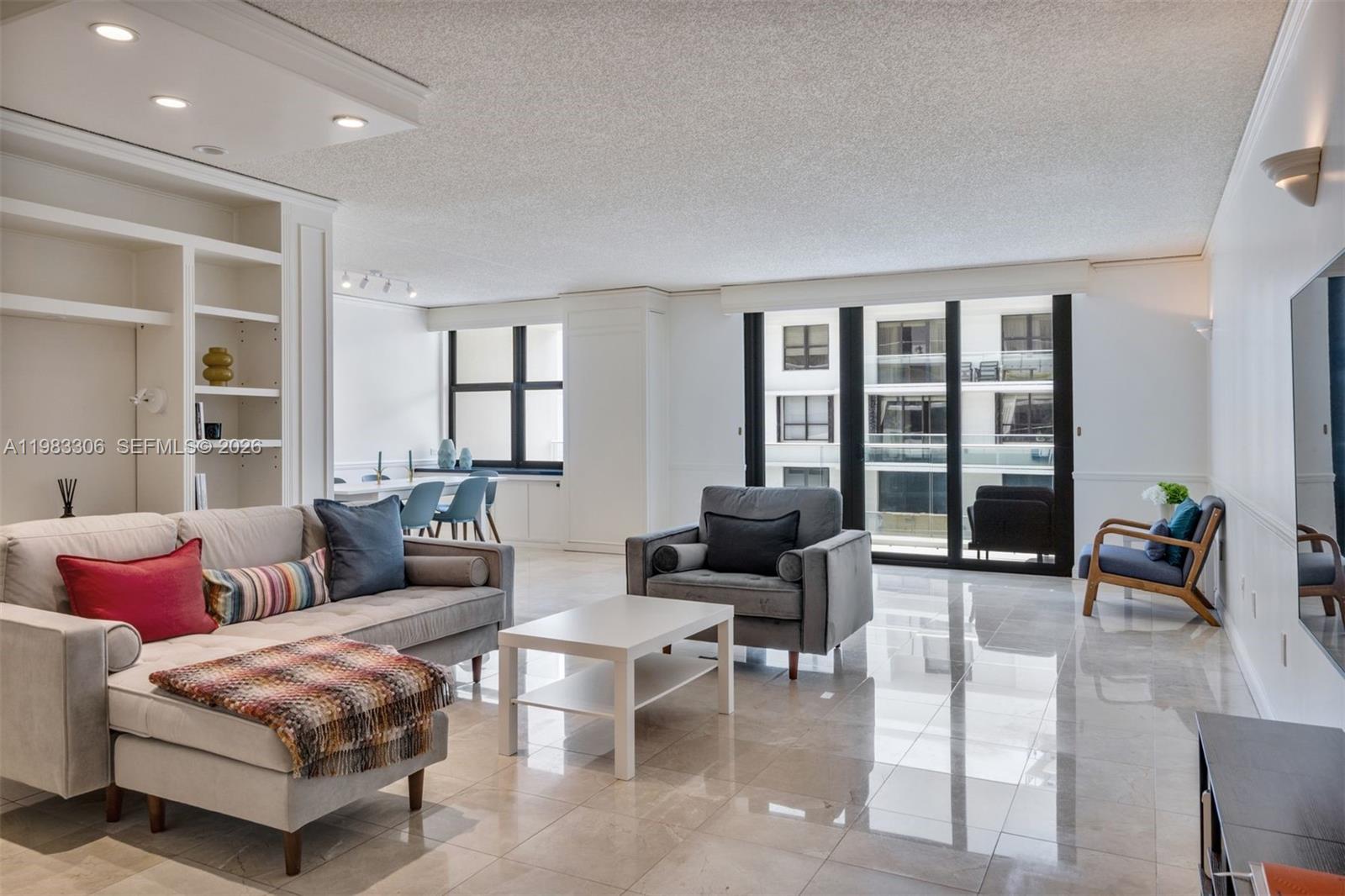 9801 Collins Avenue, Unit 19H Bal Harbour, FL 33154 - Photo 3 of 28 a living room with furniture and large windows