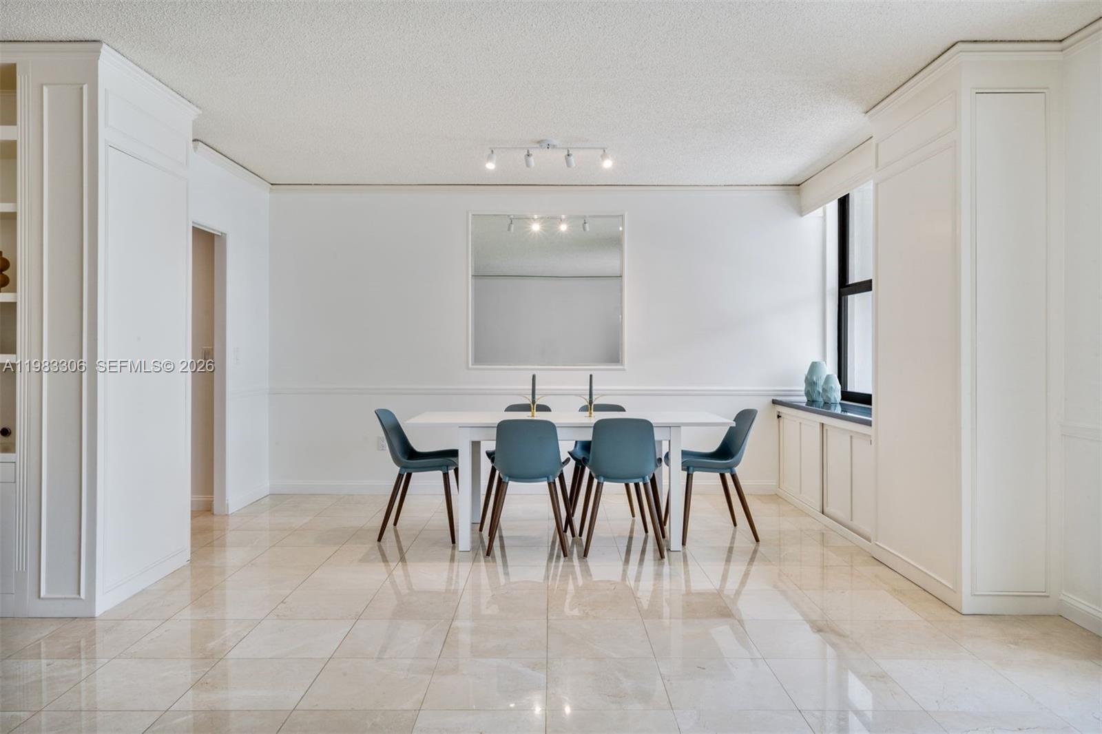 9801 Collins Avenue, Unit 19H Bal Harbour, FL 33154 - Photo 4 of 28 a view of a dining room with furniture