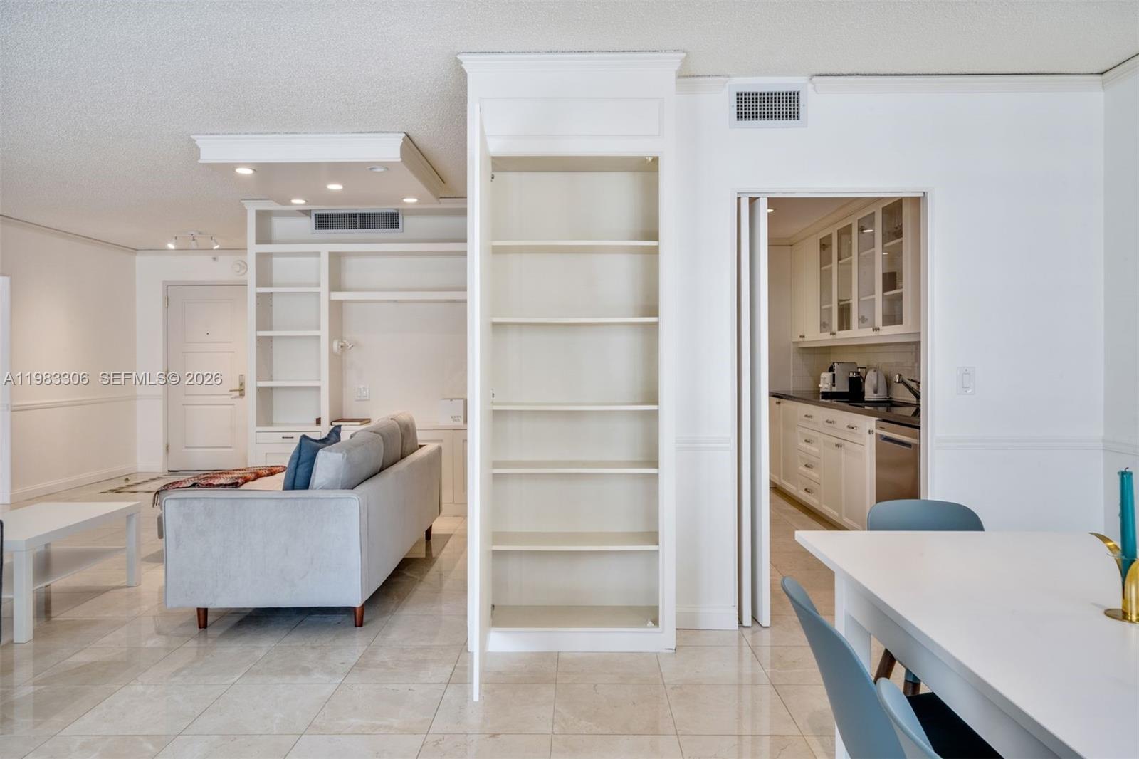 9801 Collins Avenue, Unit 19H Bal Harbour, FL 33154 - Photo 6 of 28 a kitchen with a refrigerator and white cabinets