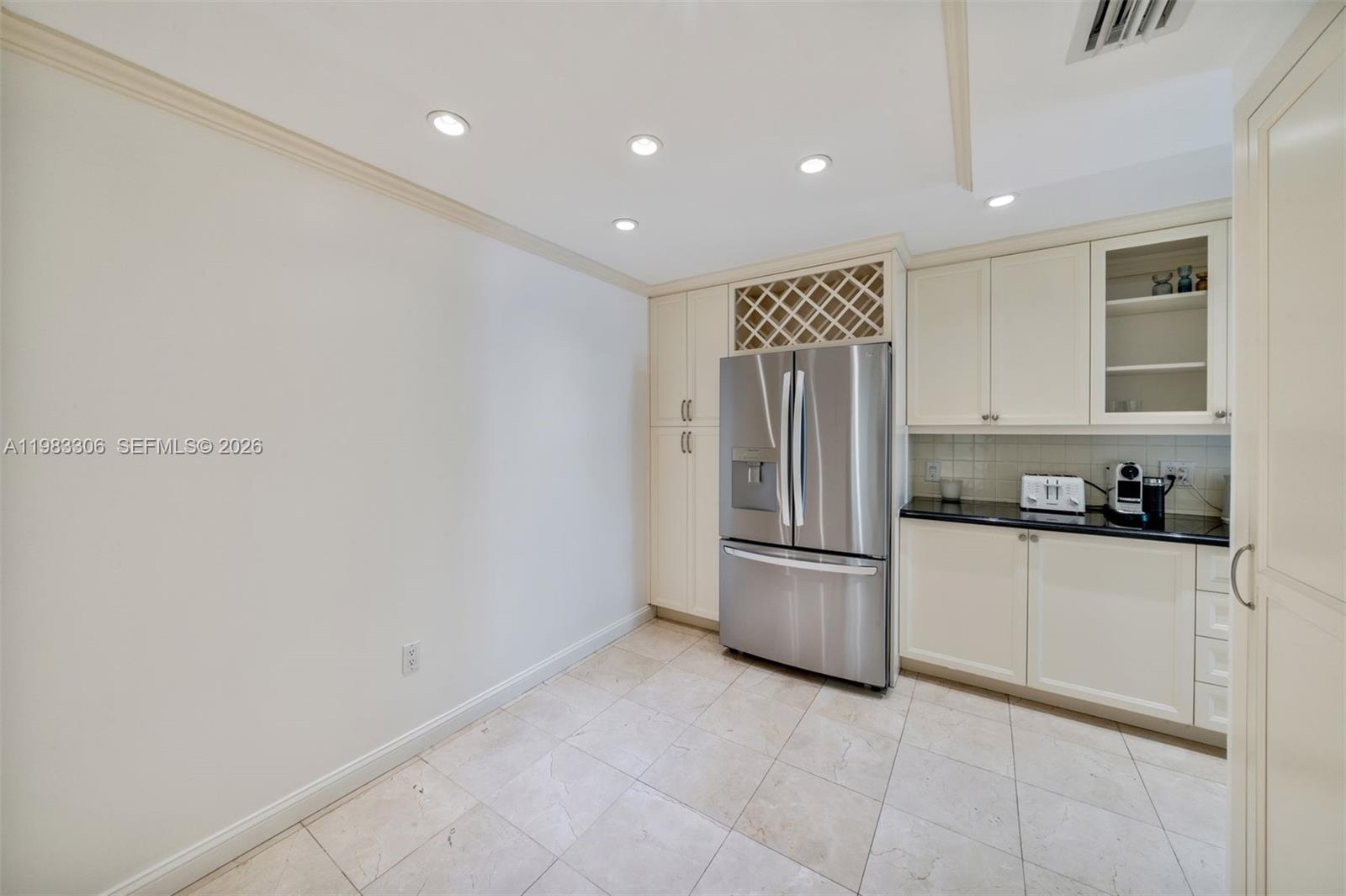 9801 Collins Avenue, Unit 19H Bal Harbour, FL 33154 - Photo 8 of 28 a kitchen with stainless steel appliances granite countertop white cabinets and refrigerator