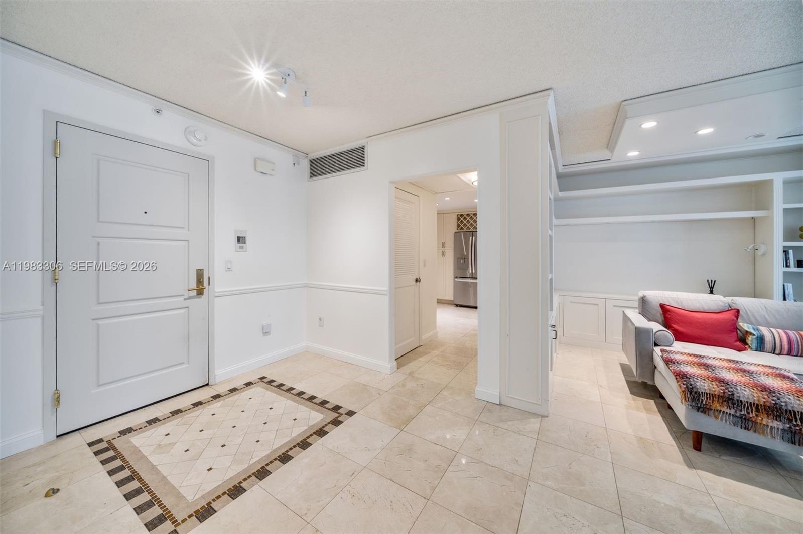 9801 Collins Avenue, Unit 19H Bal Harbour, FL 33154 - Photo 9 of 28 a bedroom with furniture and a mirror