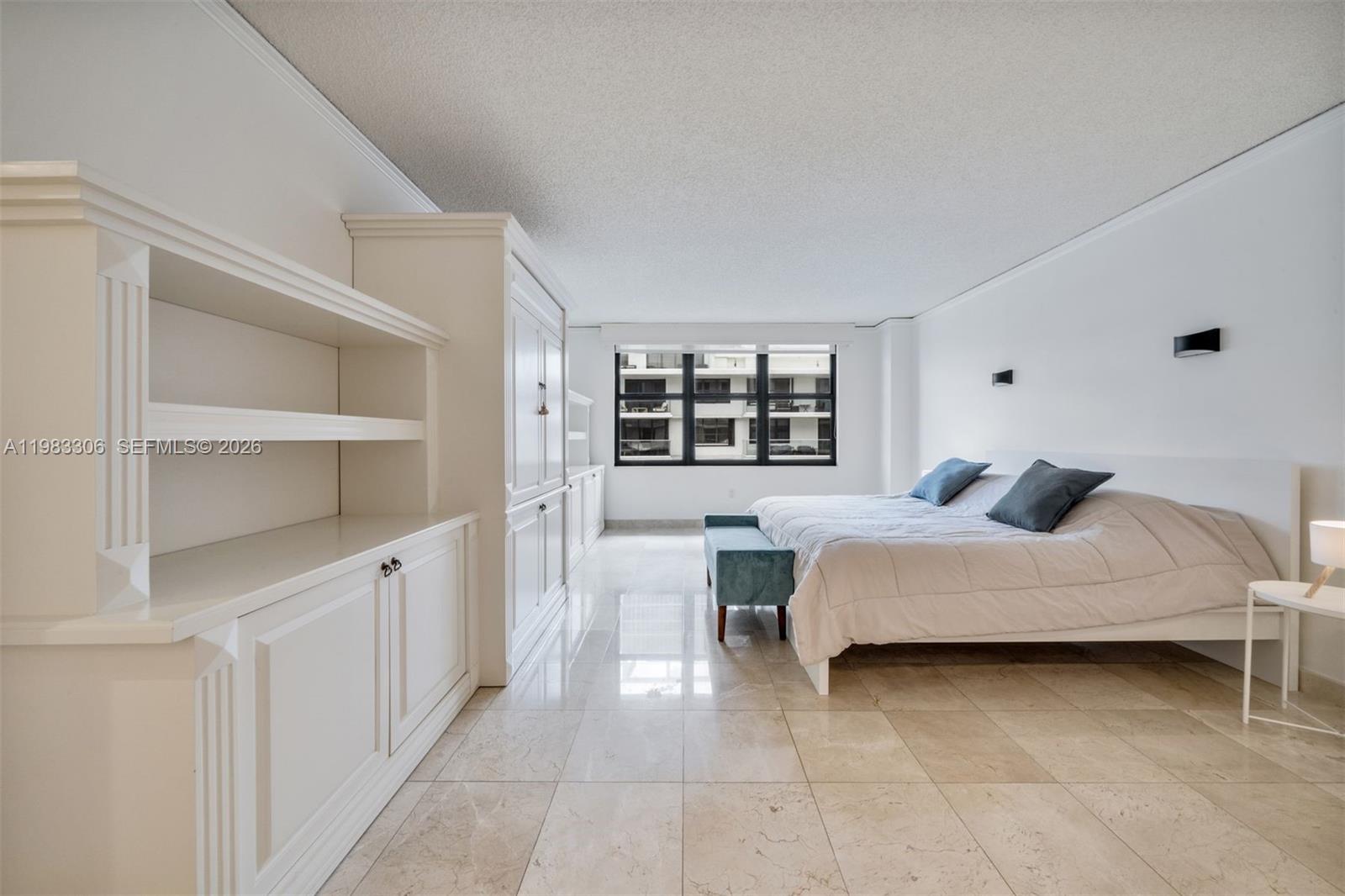 9801 Collins Avenue, Unit 19H Bal Harbour, FL 33154 - Photo 10 of 28 a bedroom with a bed and a window