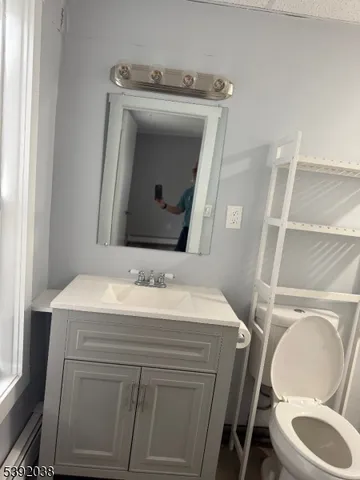 a bathroom with a toilet sink and mirror