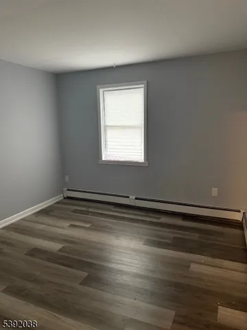 a view of a room with wooden floor and window