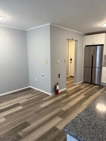 a view of a livingroom with wooden floor and cabinet