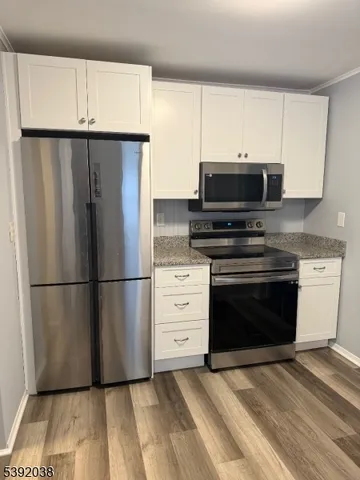 a kitchen with a refrigerator stove and microwave