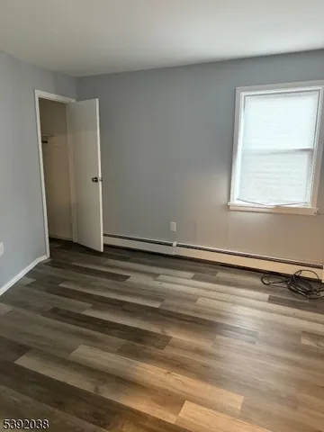 a view of a room with wooden floor and window