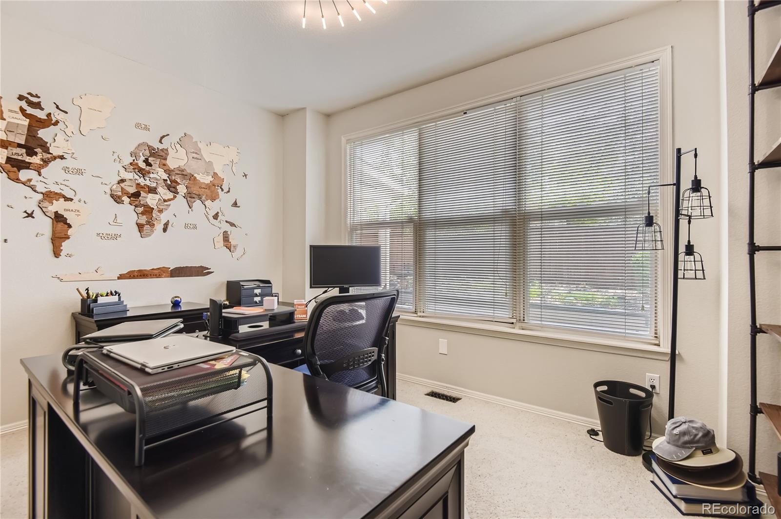 9212 Princeton Street Highlands Ranch, CO 80130 - Photo 17 of 40 a living room with furniture a flat screen tv and a floor to ceiling window