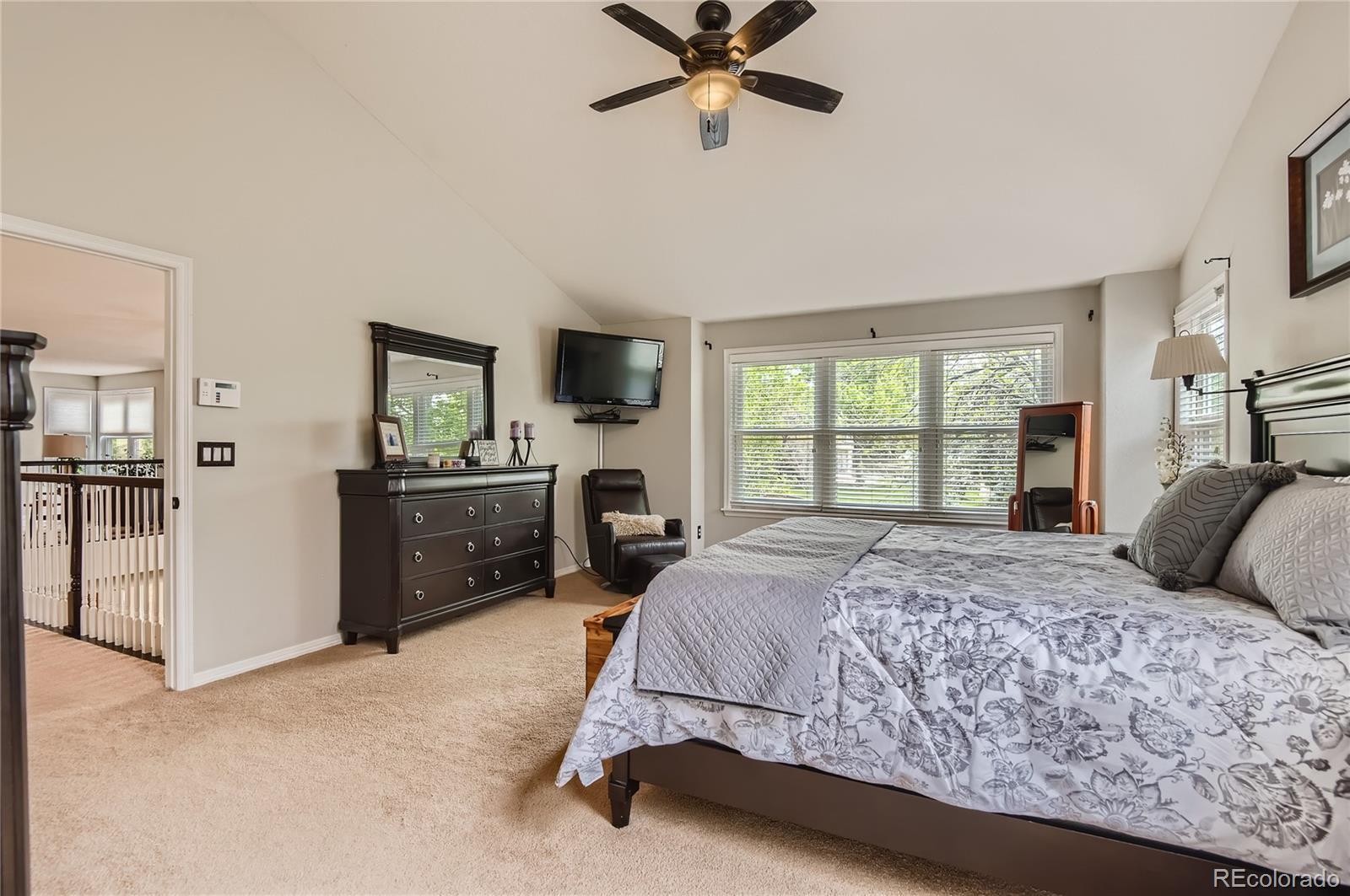 9212 Princeton Street Highlands Ranch, CO 80130 - Photo 20 of 40 a bedroom with a large bed and a tv