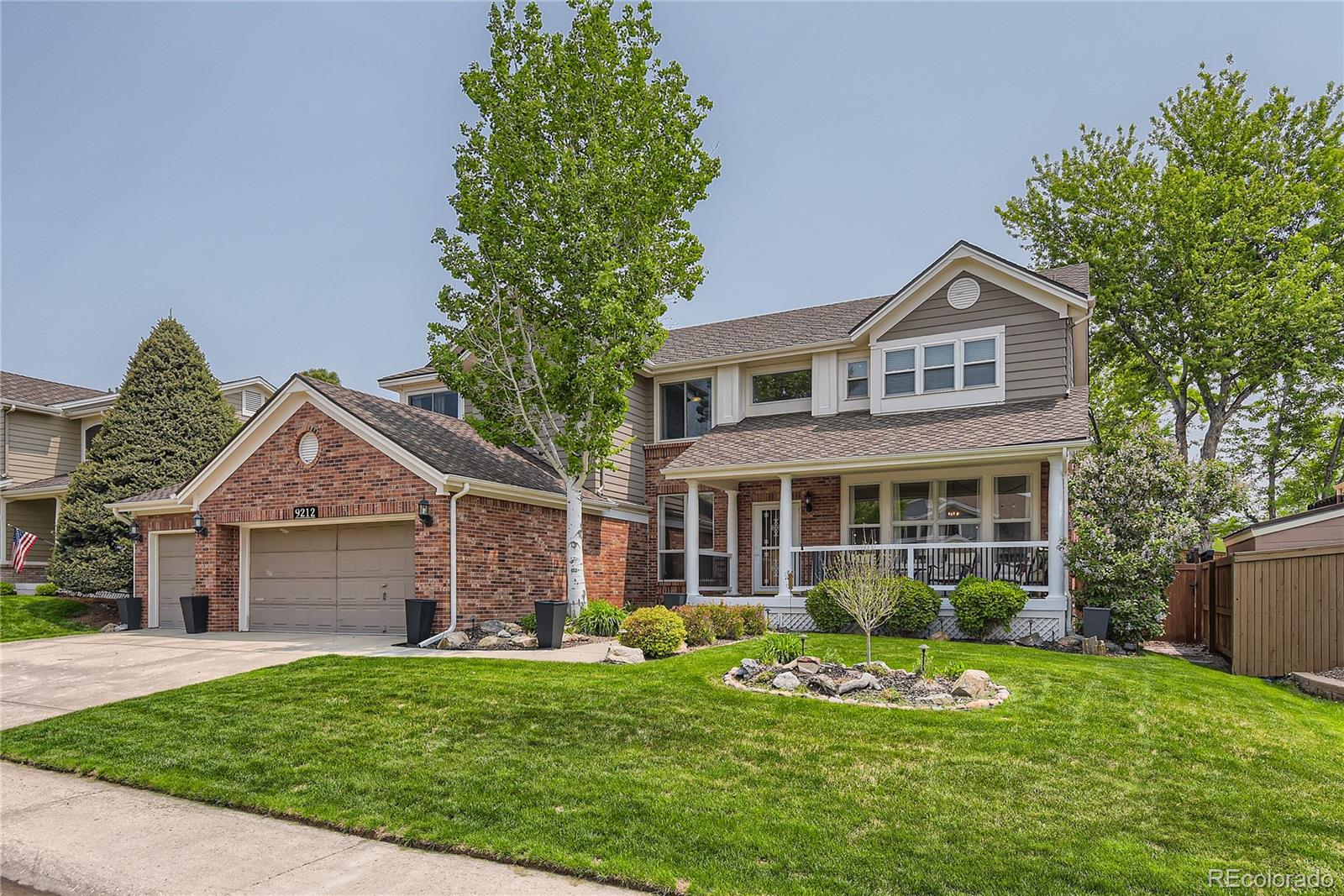 9212 Princeton Street Highlands Ranch, CO 80130 - Photo 2 of 40 a front view of a house with a garden and porch