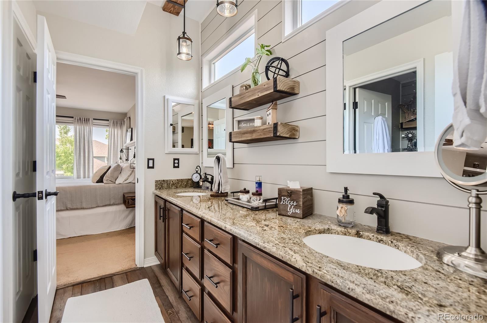 9212 Princeton Street Highlands Ranch, CO 80130 - Photo 23 of 40 a bathroom with a granite countertop sink mirror and vanity